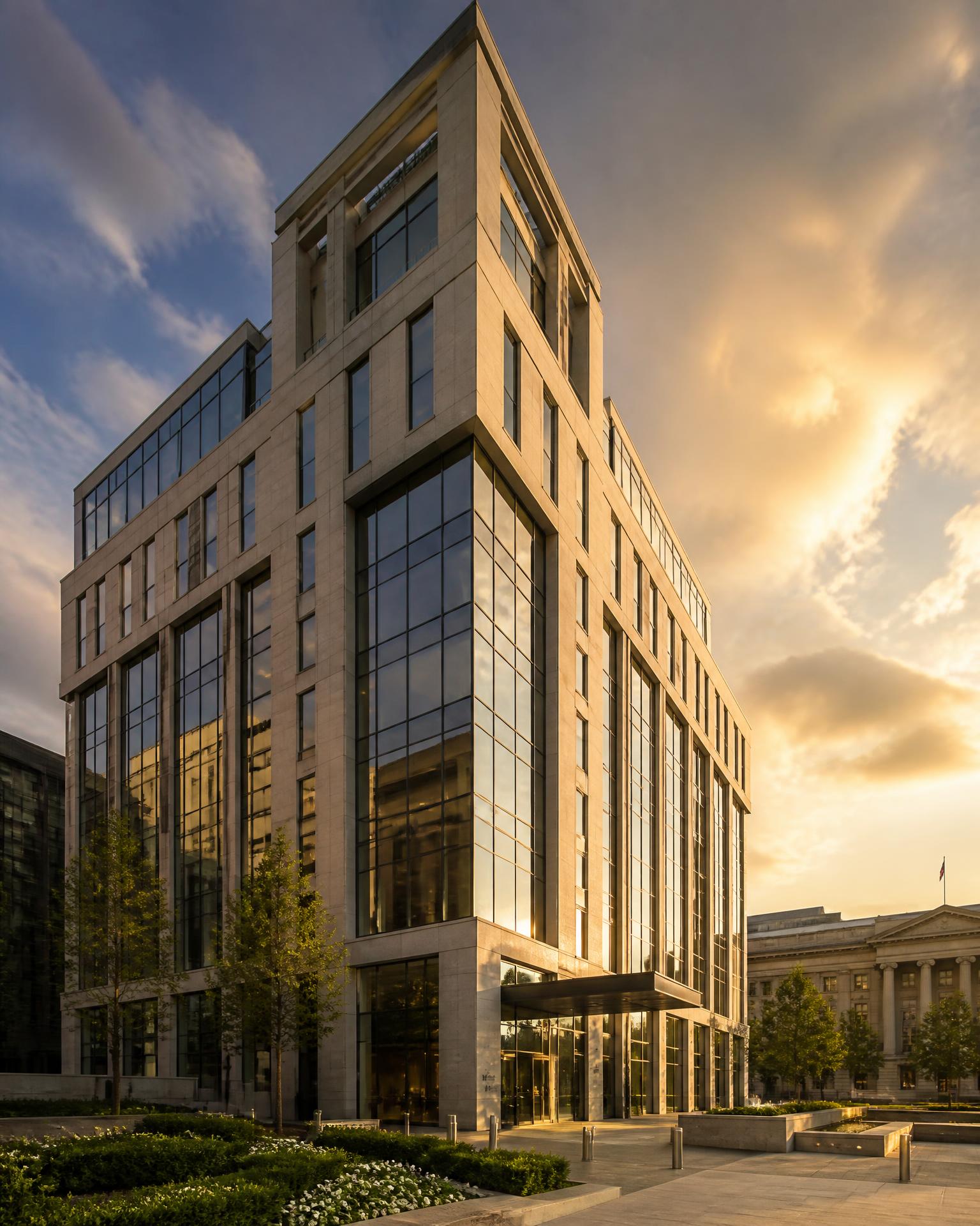Modern limestone and glass commercial development in Washington, DC at golden hour